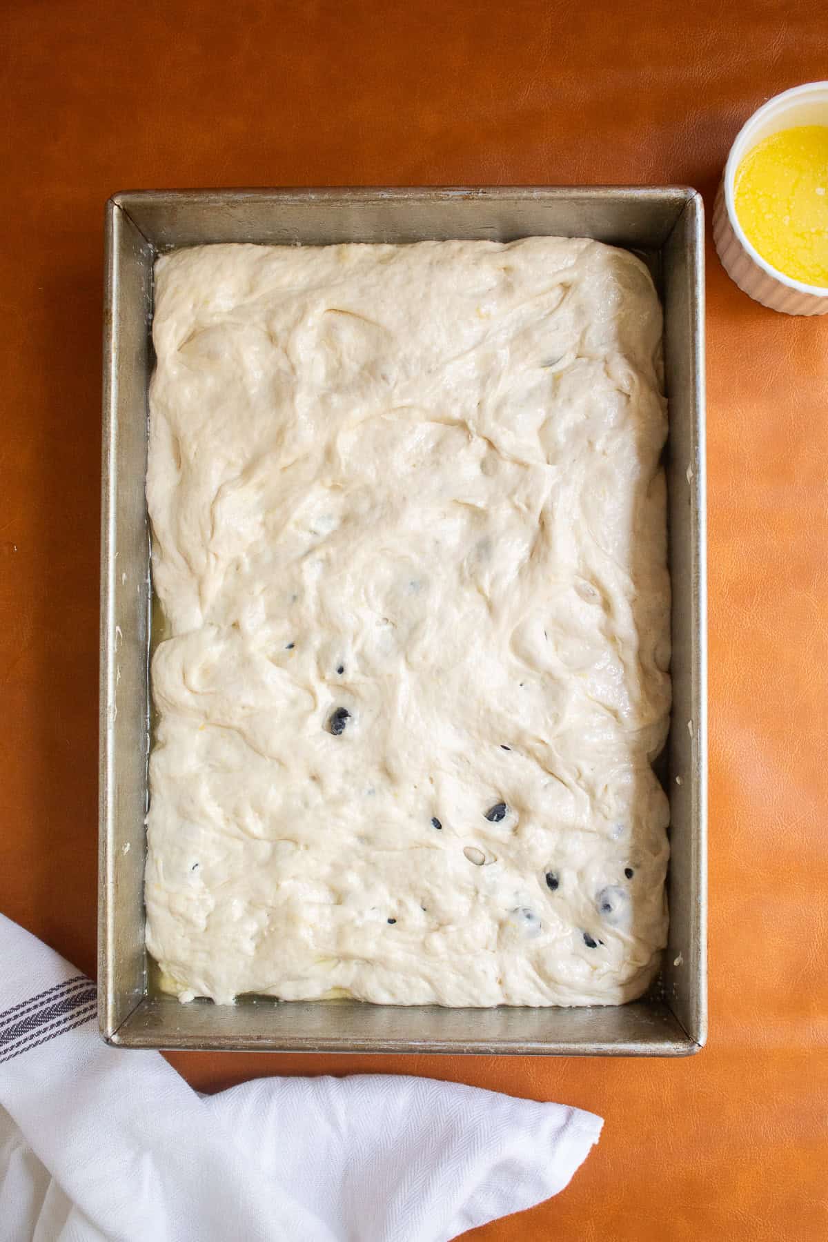 The dough is stretched to cover the entire inside of the pan.