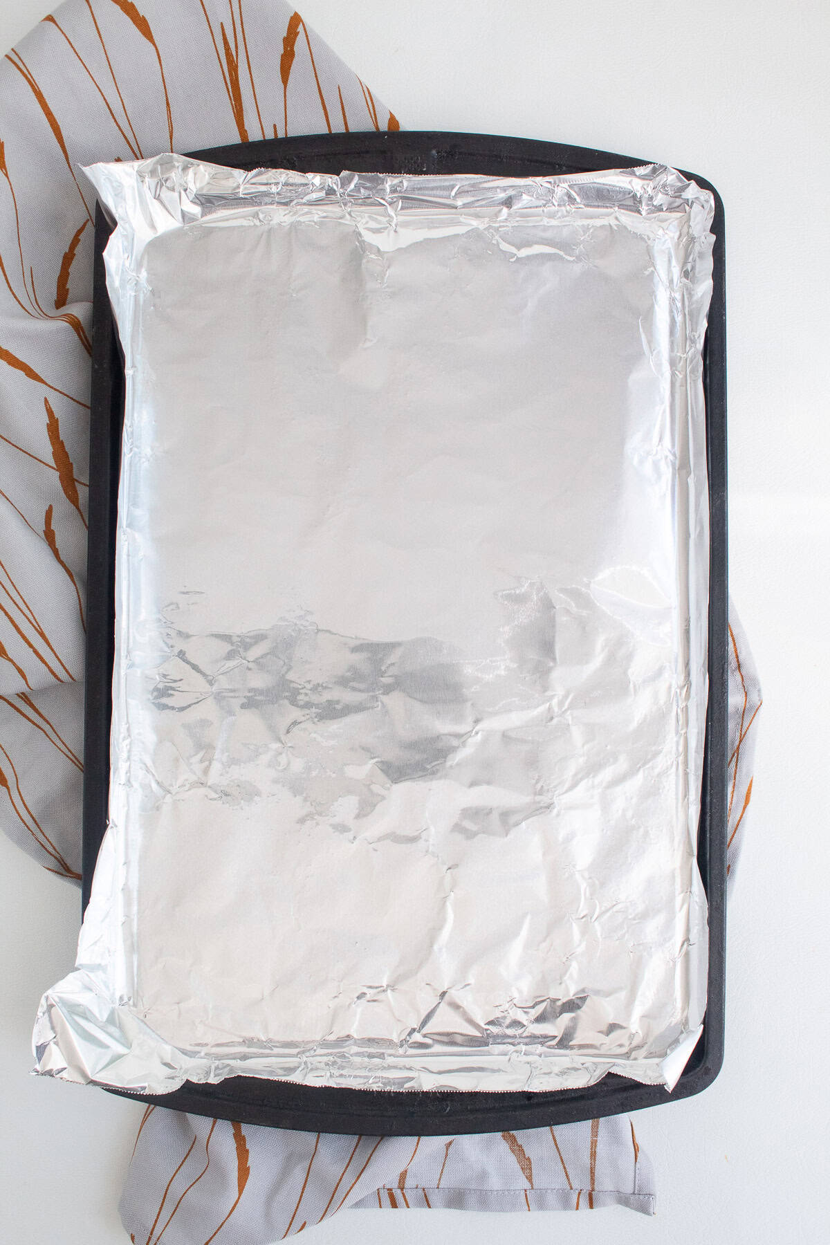 A baking sheet is lined with foil.