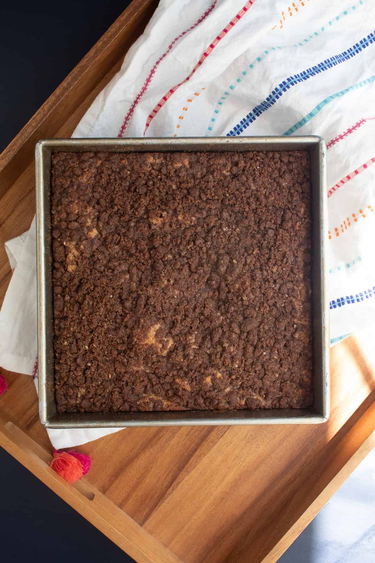 The baked coffee cake has a bumpy texture and golden edges.