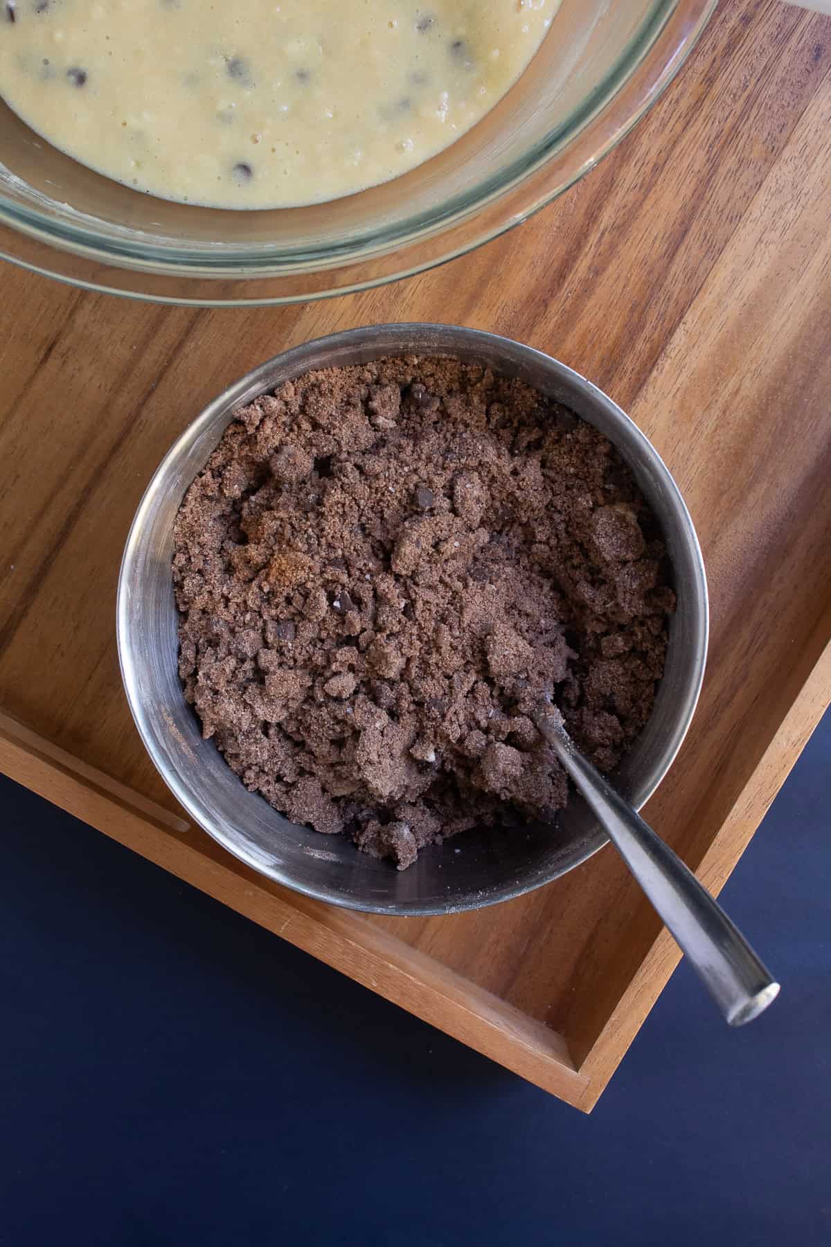 The streusel is mixed together, forming large clumps and sandy crumbs.