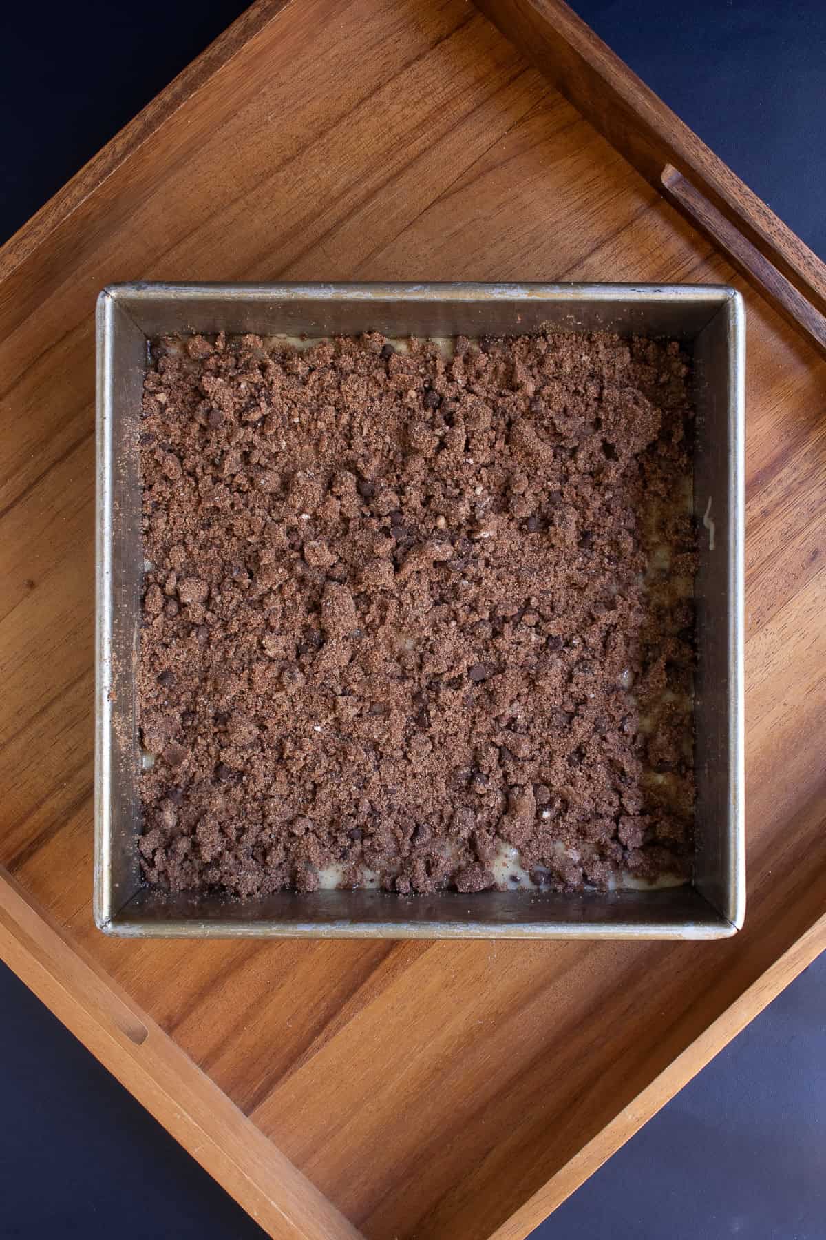 The layer of coffee bake batter is covered with a layer of dark brown mocha streusel.