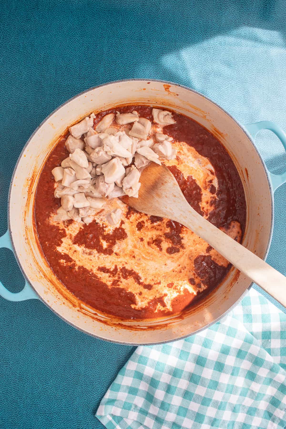 Heavy cream and cooked chicken are added to the tomato and chorizo mixture.