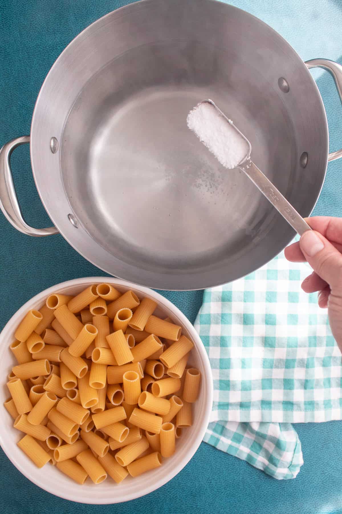 Kosher salt is added to the boiling water.