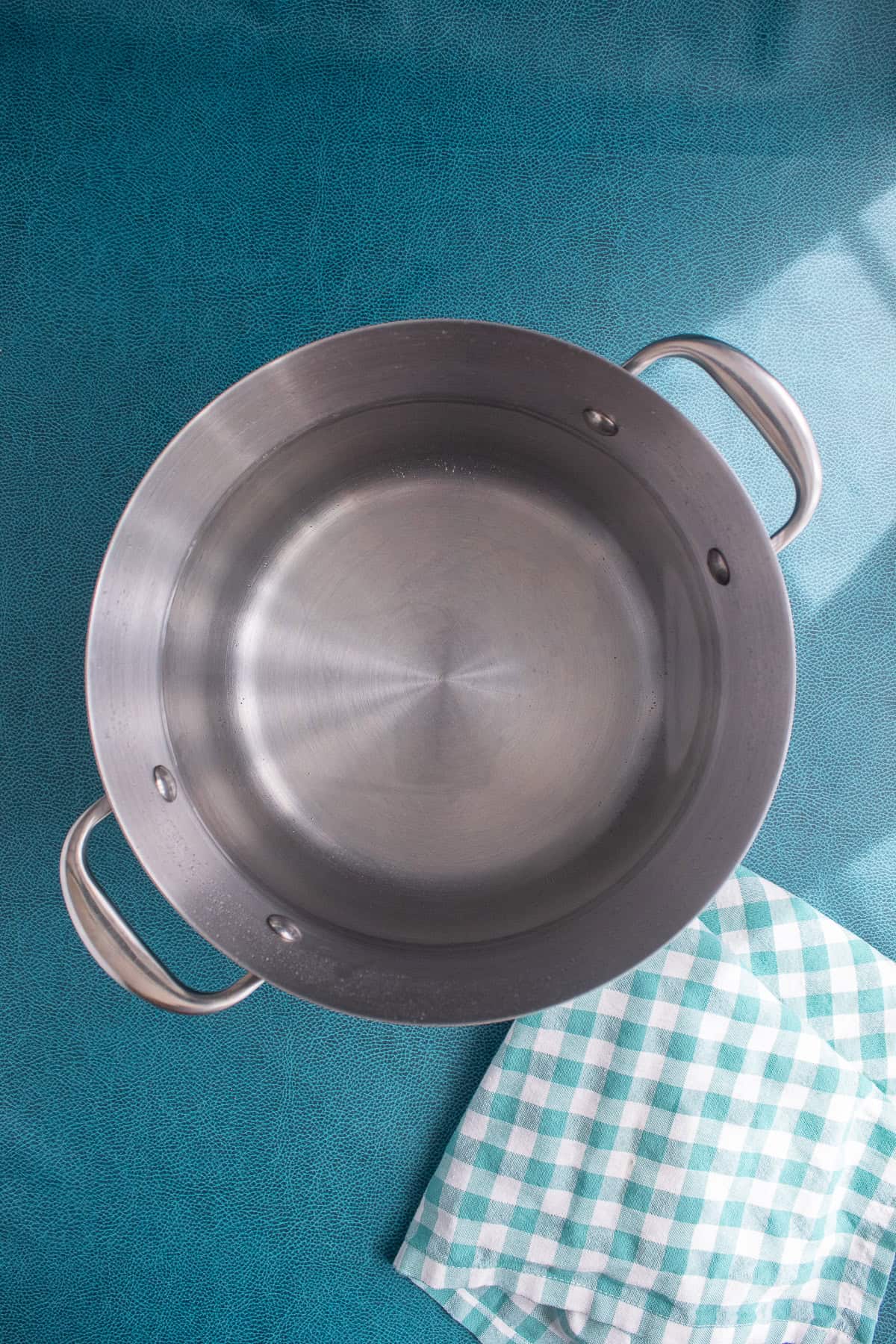 A large pot of water is heated for cooking the pasta.