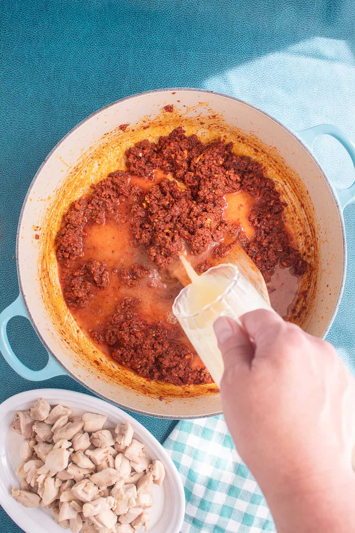 Chicken broth deglazes the pot after the chorizo is browned.