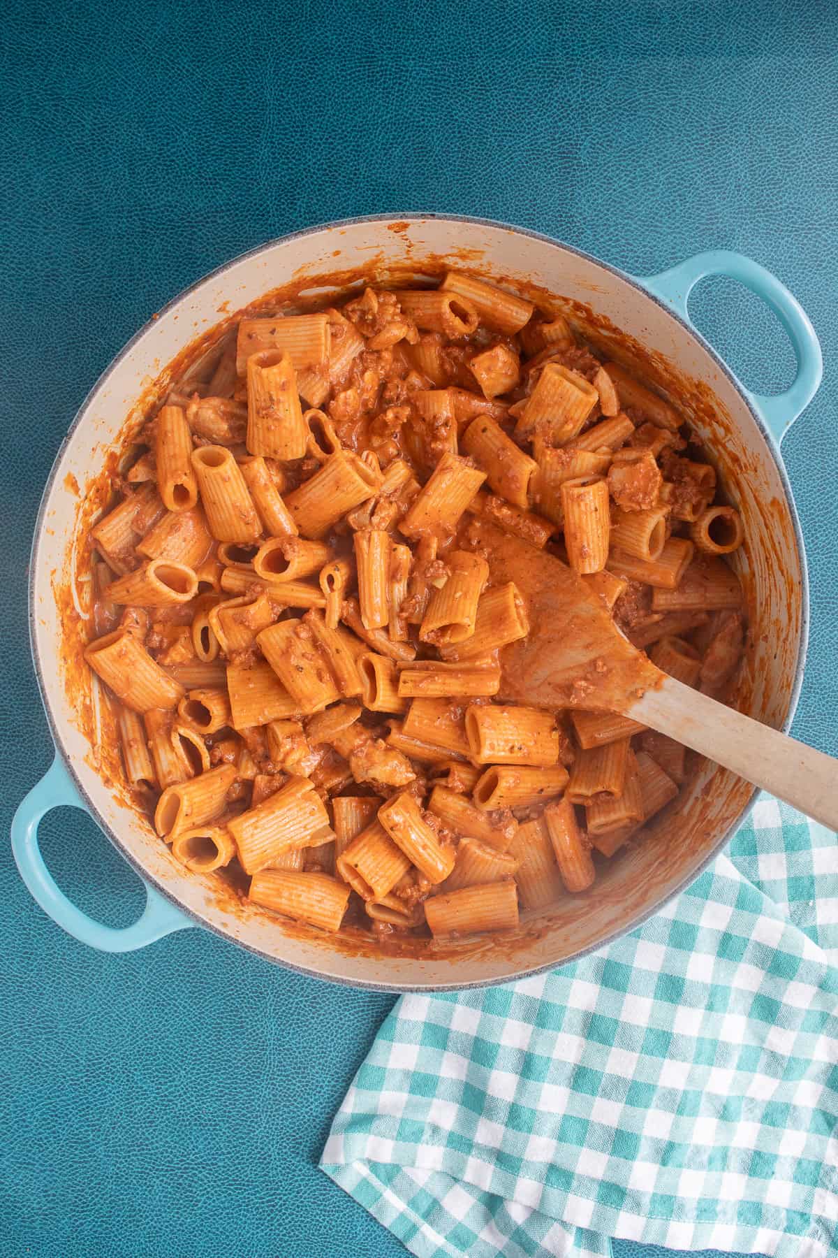 The pasta is coated with the sauce in the large pot.