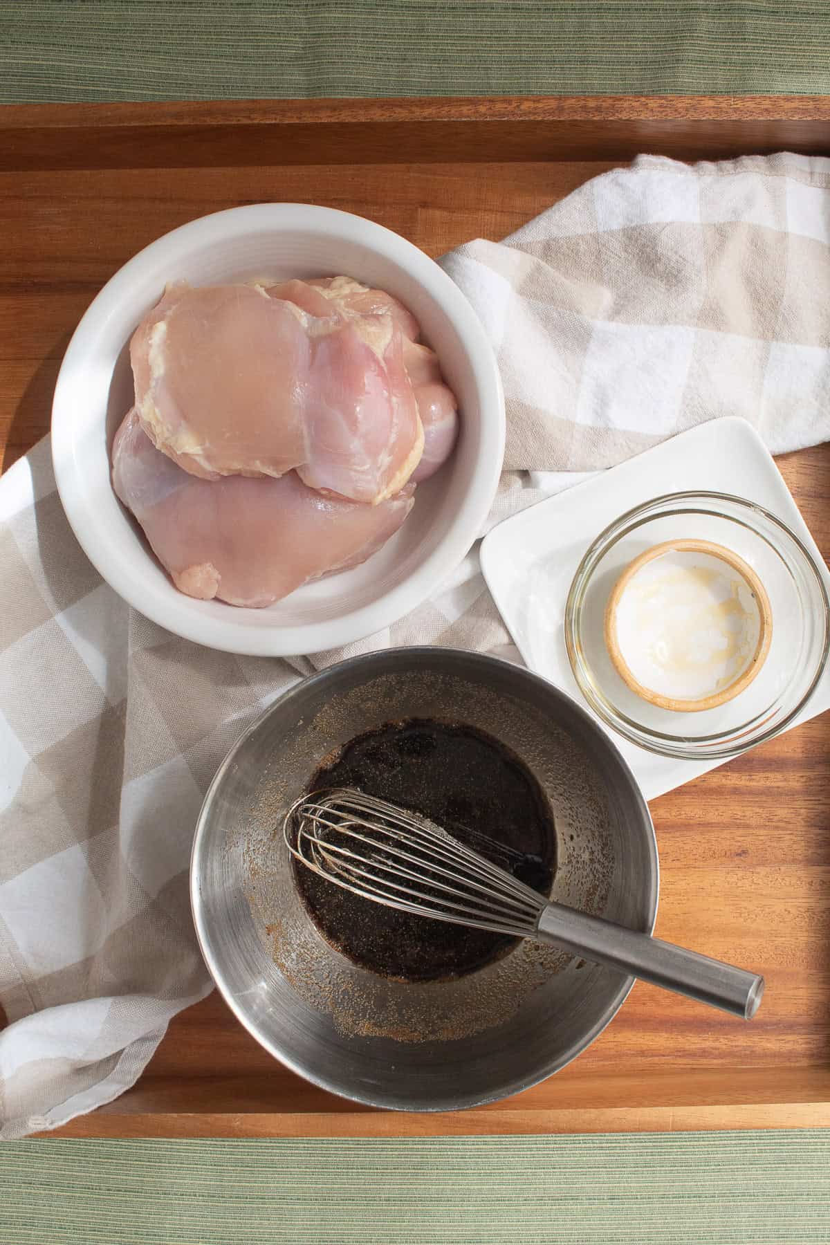 Balsamic marinade ingredients are whisked together in a small bowl.