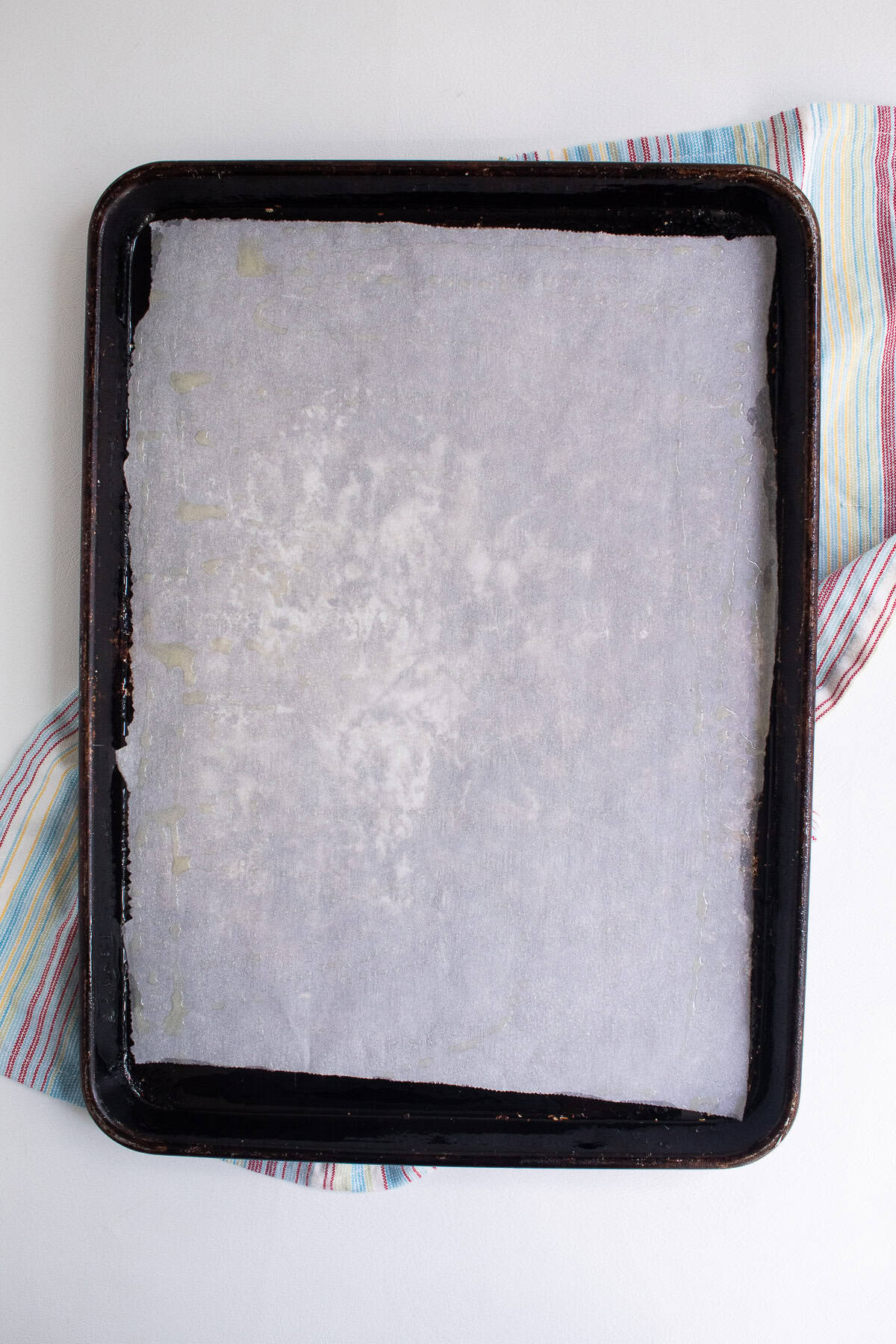 A sheet pan is lined with parchment paper.