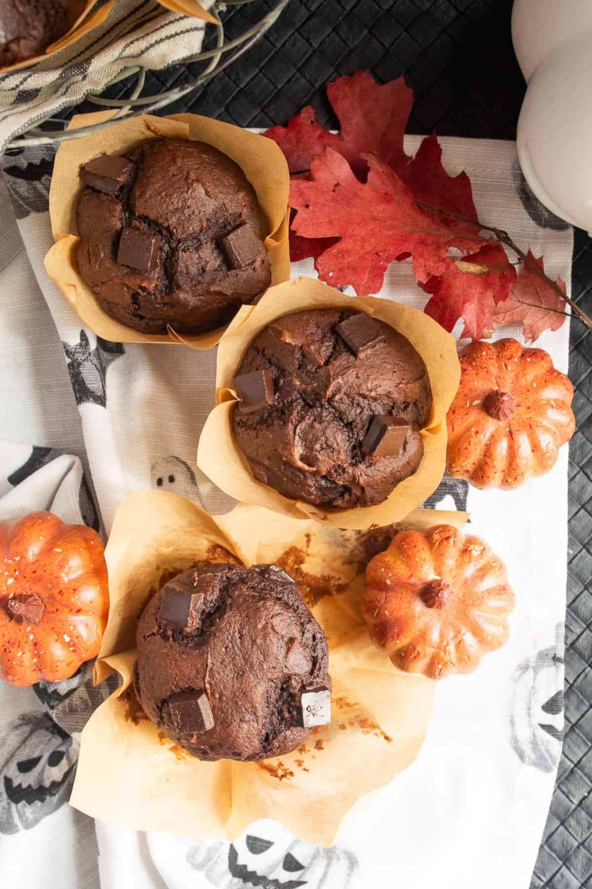 Baked muffins are on a Halloween-themed napkin.