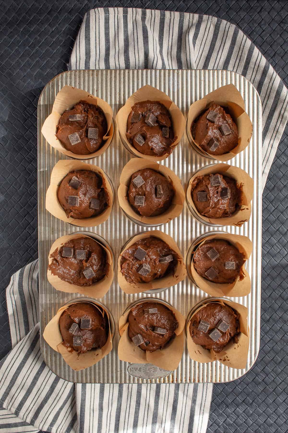 The muffin batter is studded with additional chocolate chips.