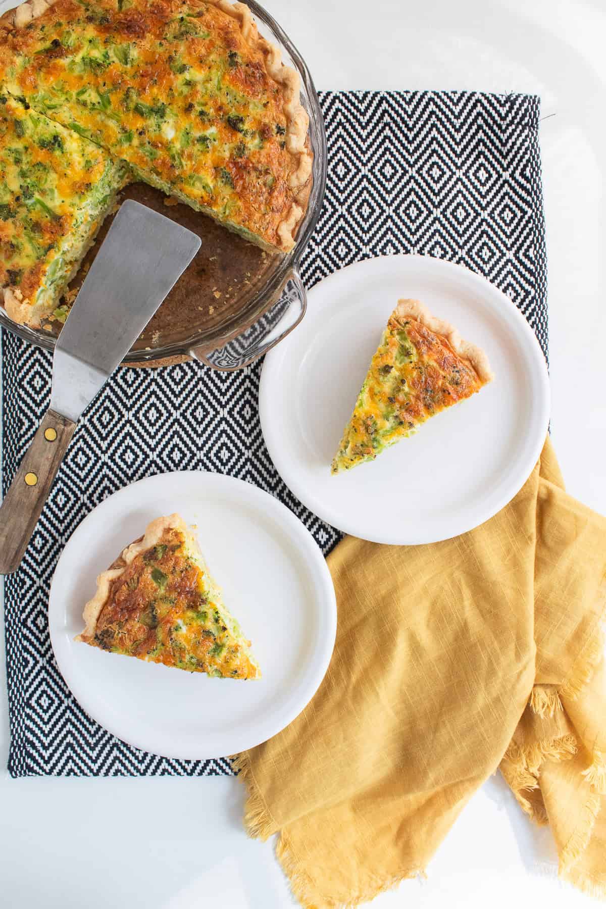 Servings of the quiche sit on white plates.