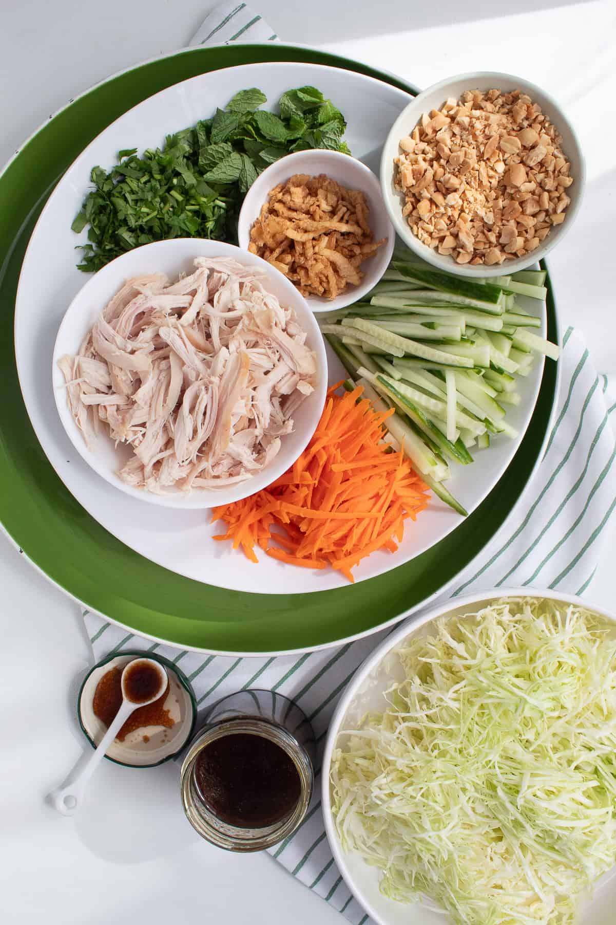 The components of the salad are displayed on various platters and bowls for easy serving.