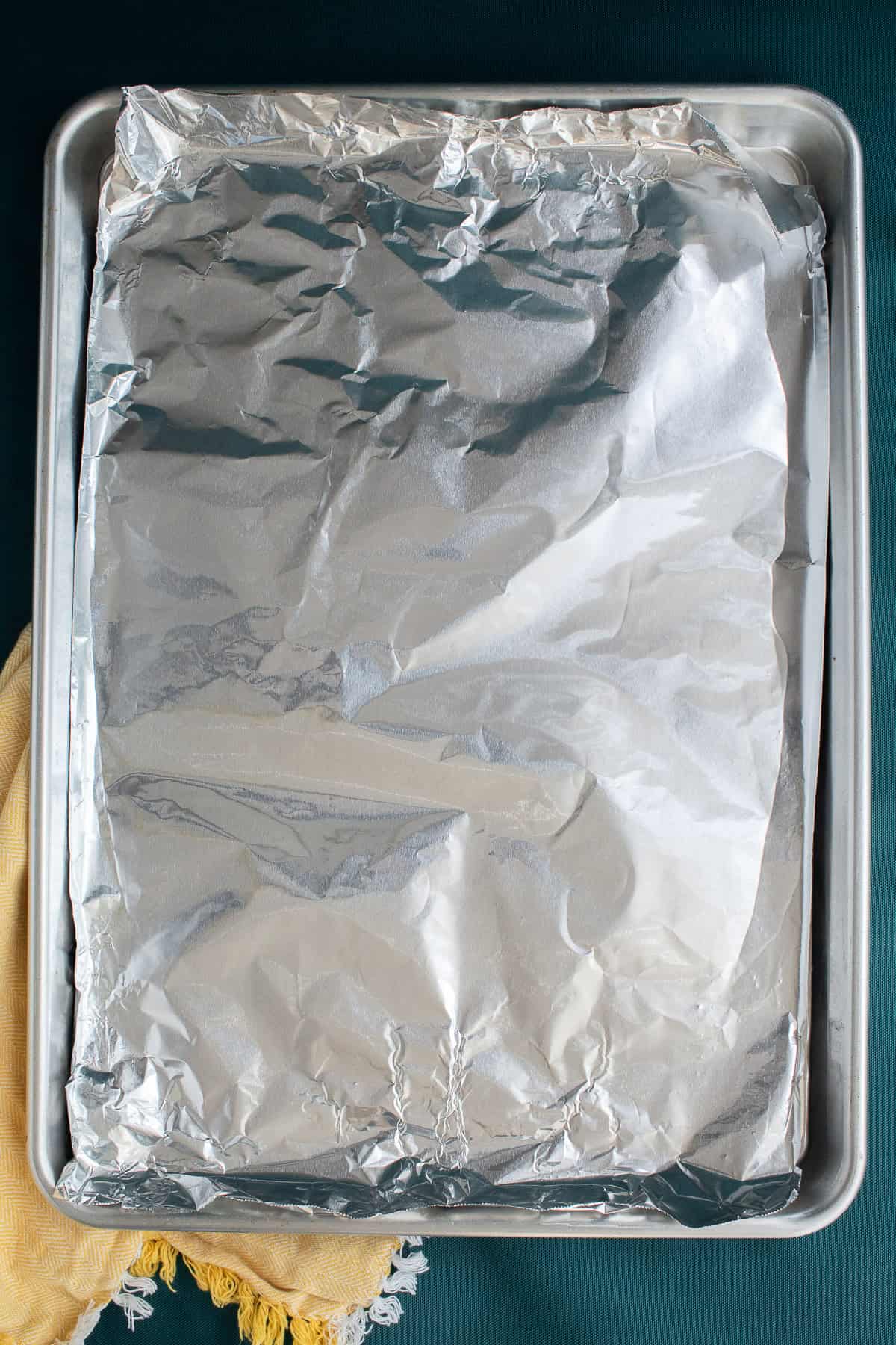 A sheet pan is lined with aluminum foil.