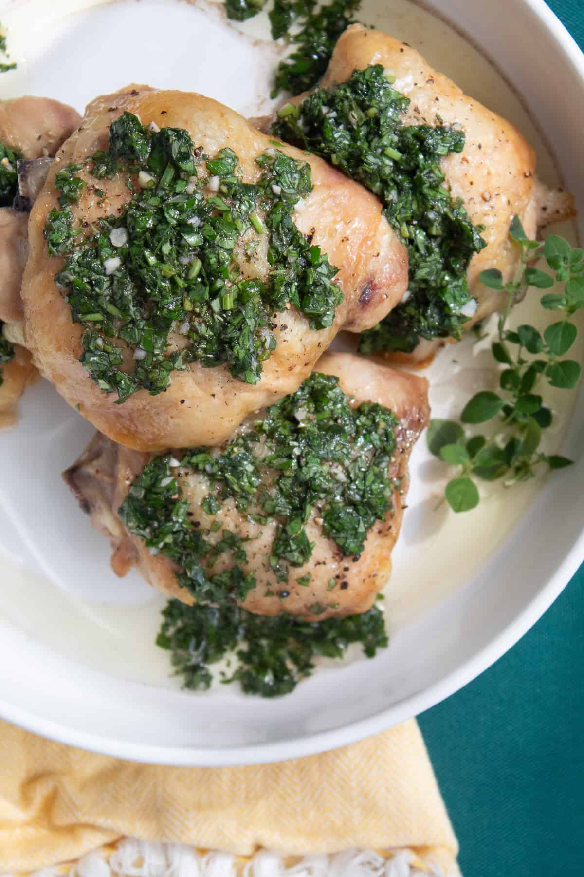 The deep green chimichurri sauce has specks of garlic and chopped parsley and oregano.