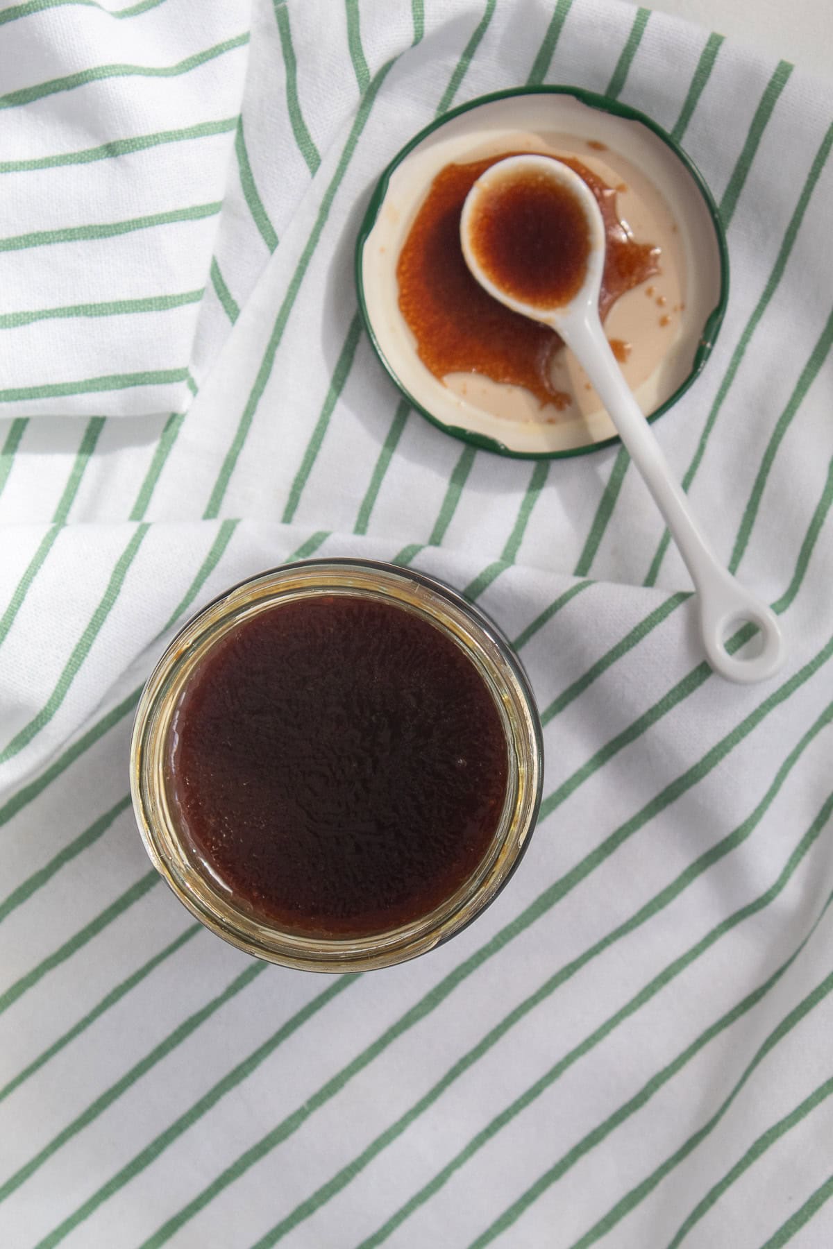 The hoisin vinaigrette is shaken in a jar to blend it.