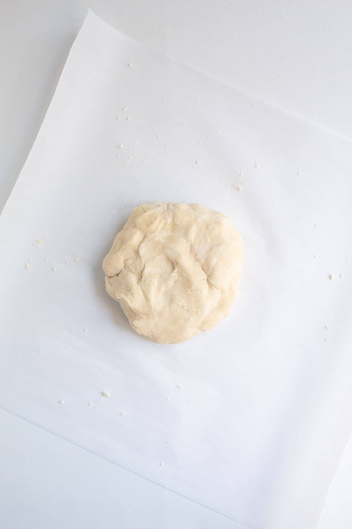 Once the heaps of crust dough are pressed together they form a solid disk.