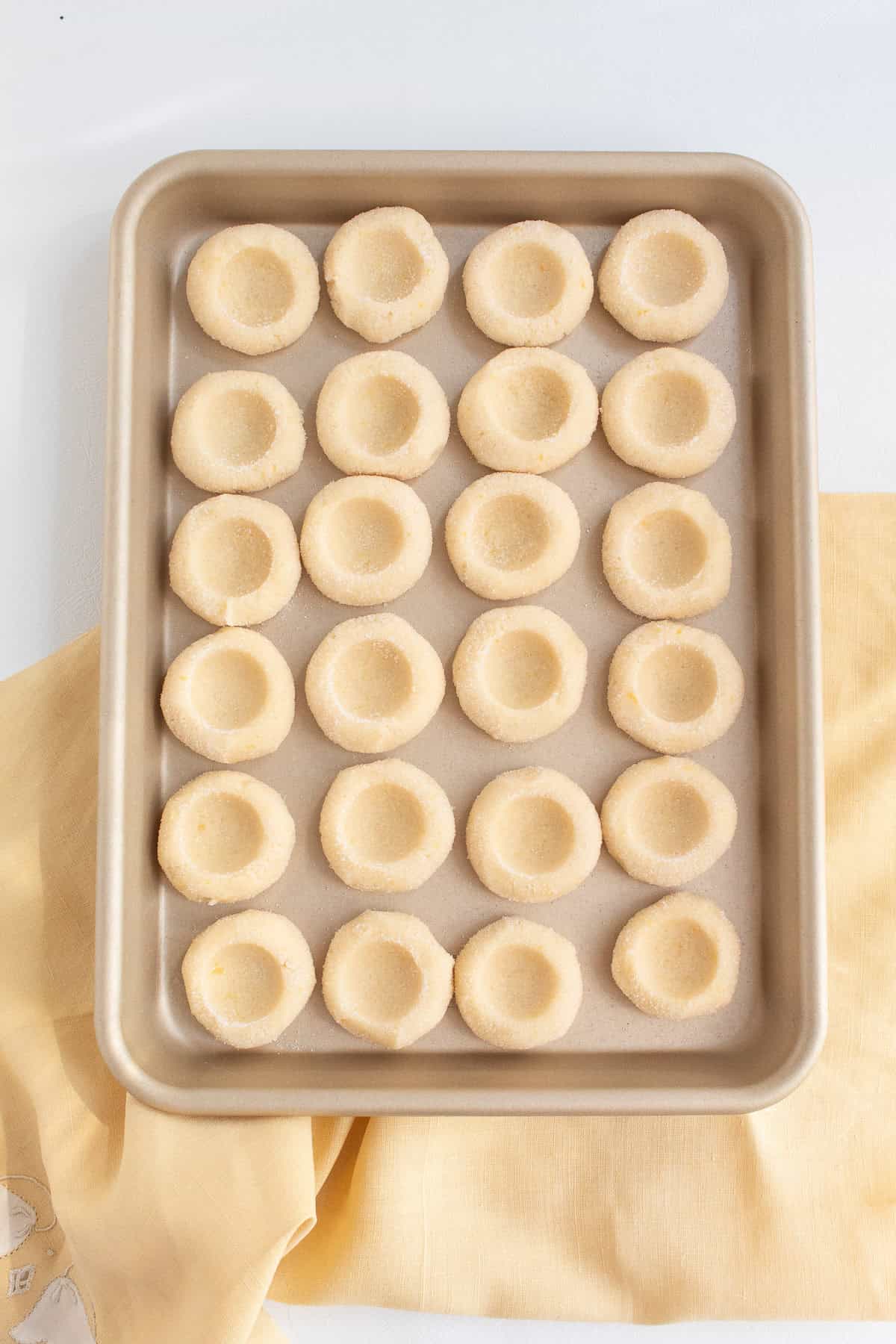 The thumbprint cookies are chilled to firm up before filling and baking.