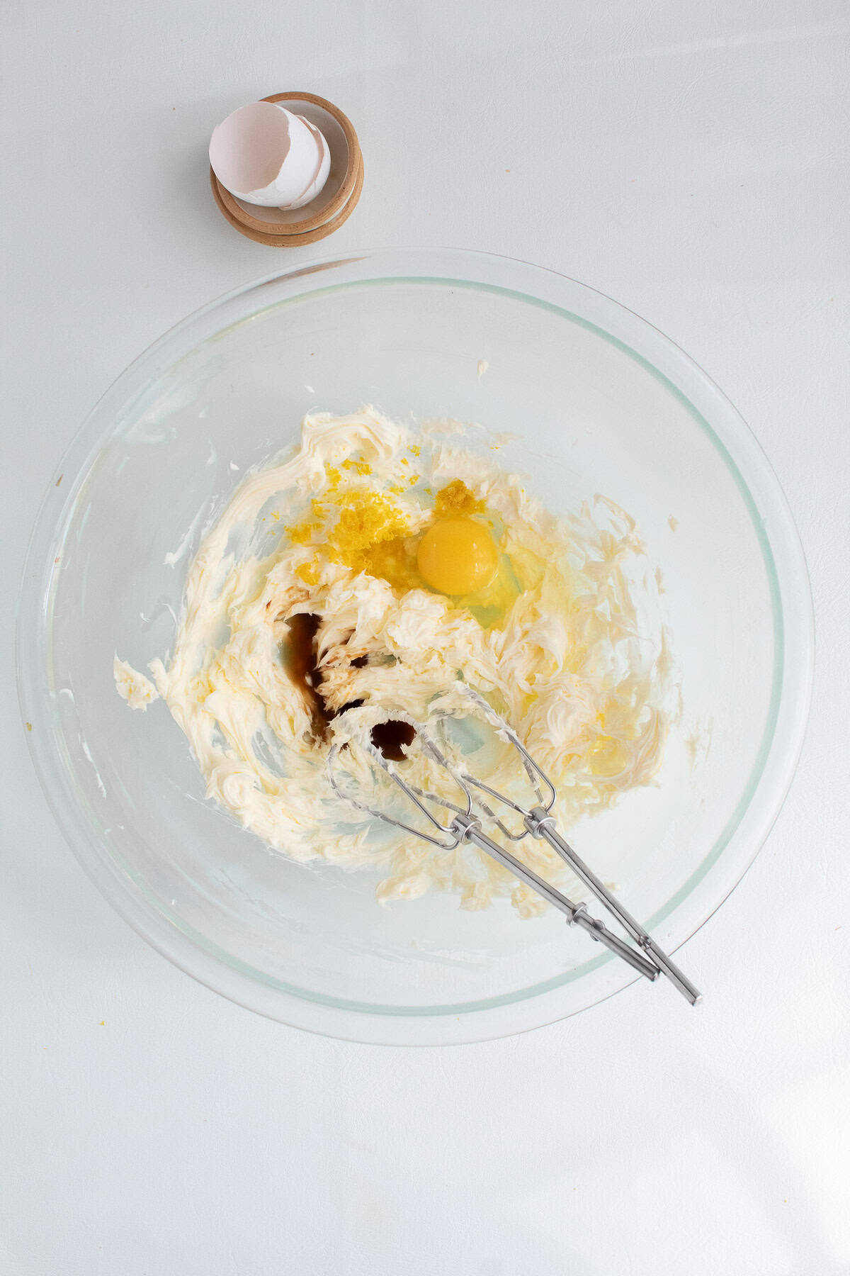 Vanilla, egg, and lemon zest are added to the whipped butter.