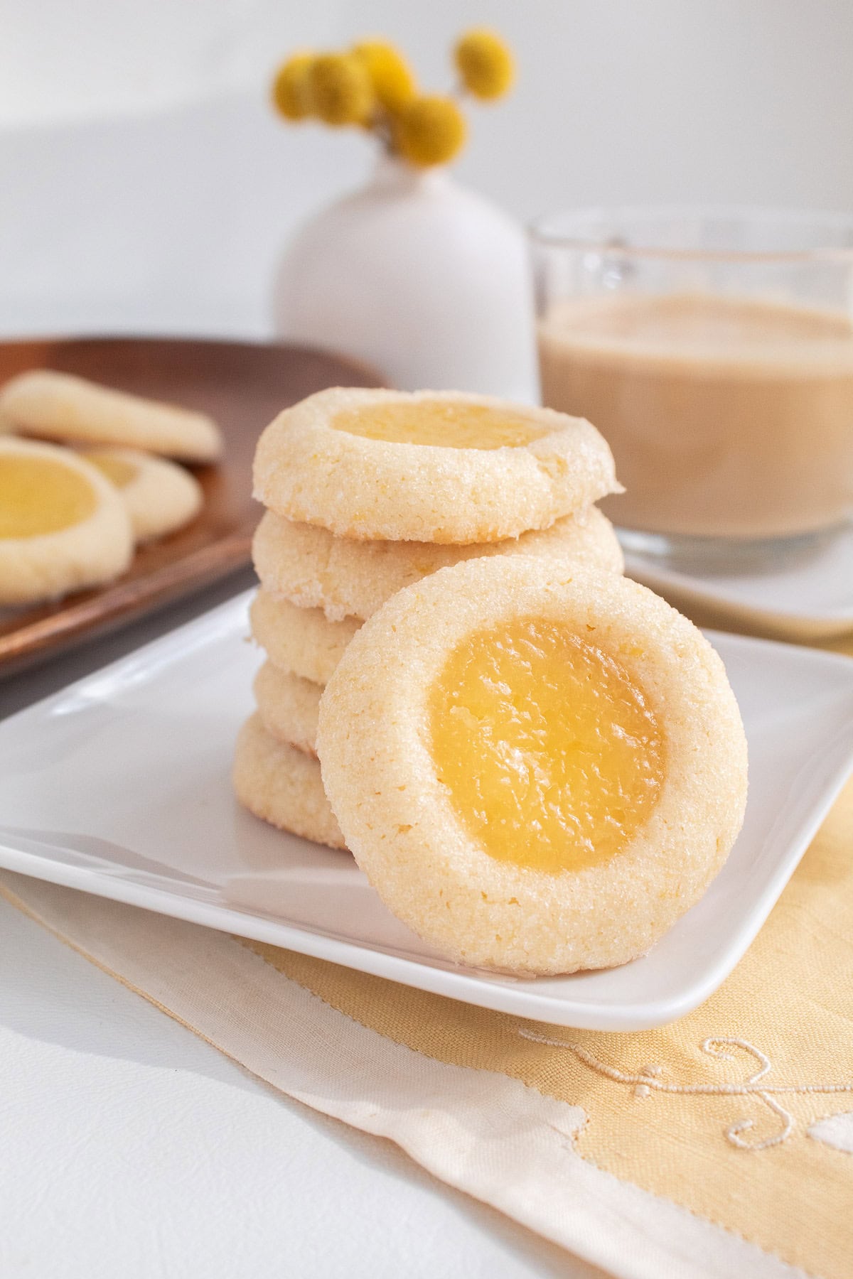 A stack of baked cookies features golden edges and a sunny yellow filling.