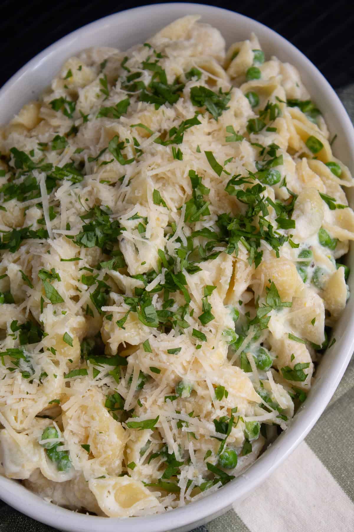 The pasta is piled high into an oval serving dish.