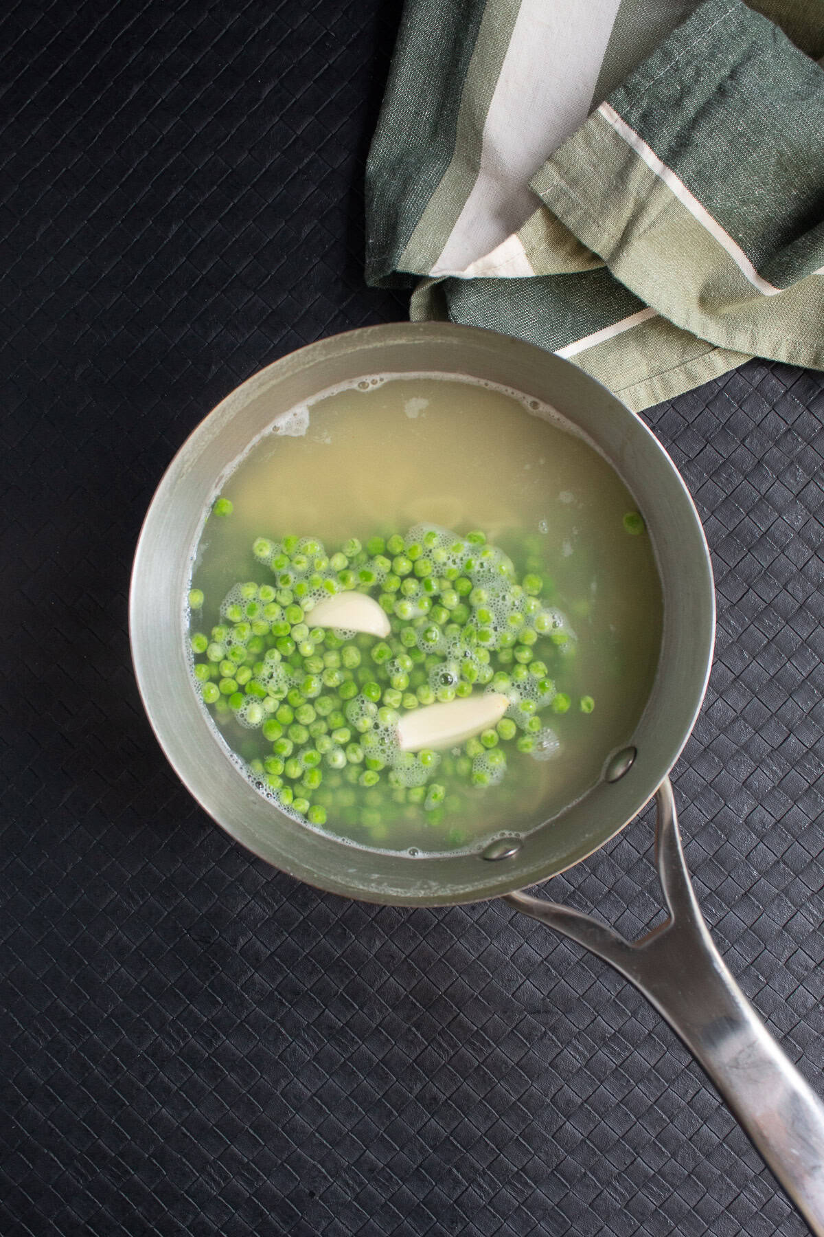 The peas are cooked in the pot right with the pasta and garlic.