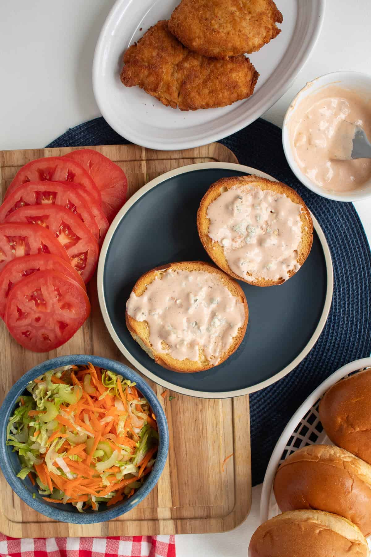 The two halves of the toasted bun are slathered with the spicy blue cheese sauce.