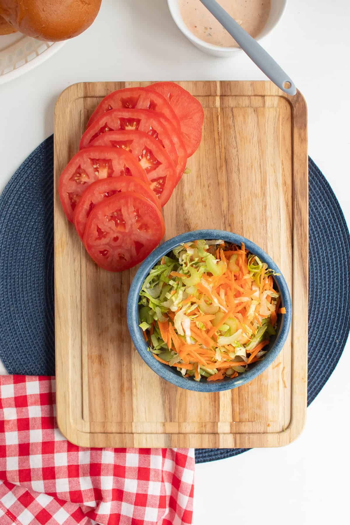 The sandwich slaw is a mixture of thinly sliced celery, shredded carrot, and shredded lettuce.