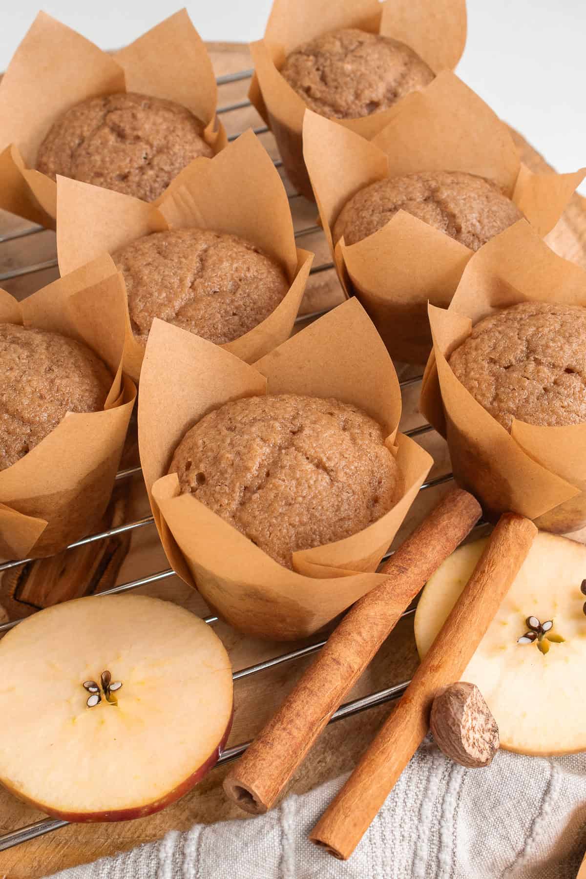 Muffins baked in liners are cooled on a wire rack.