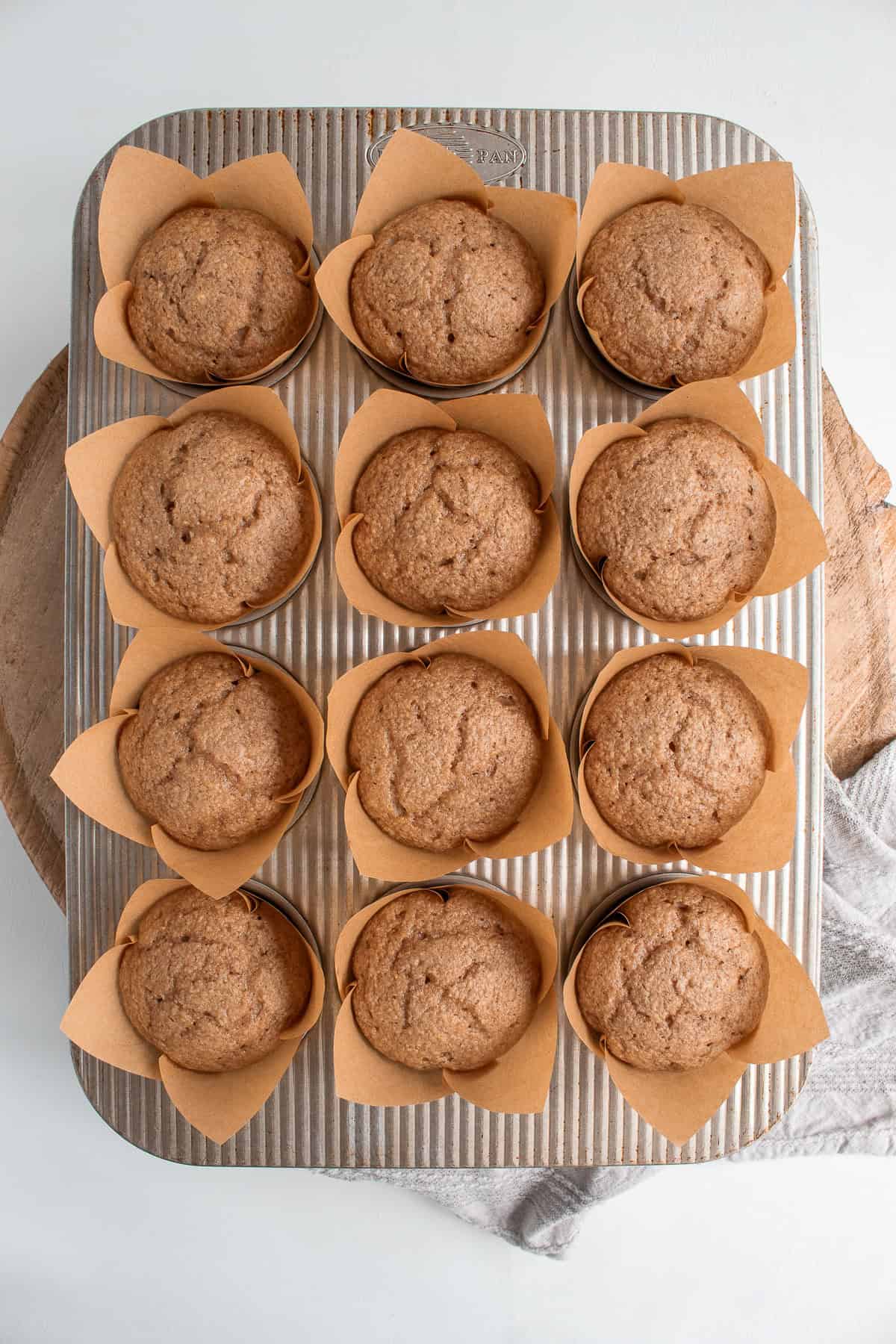The baked muffins will rise and fill much of the tulip liners.
