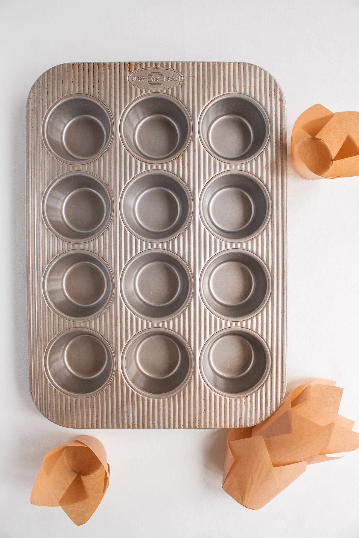 A sturdy deep-well muffin tin is used for baking the muffins.