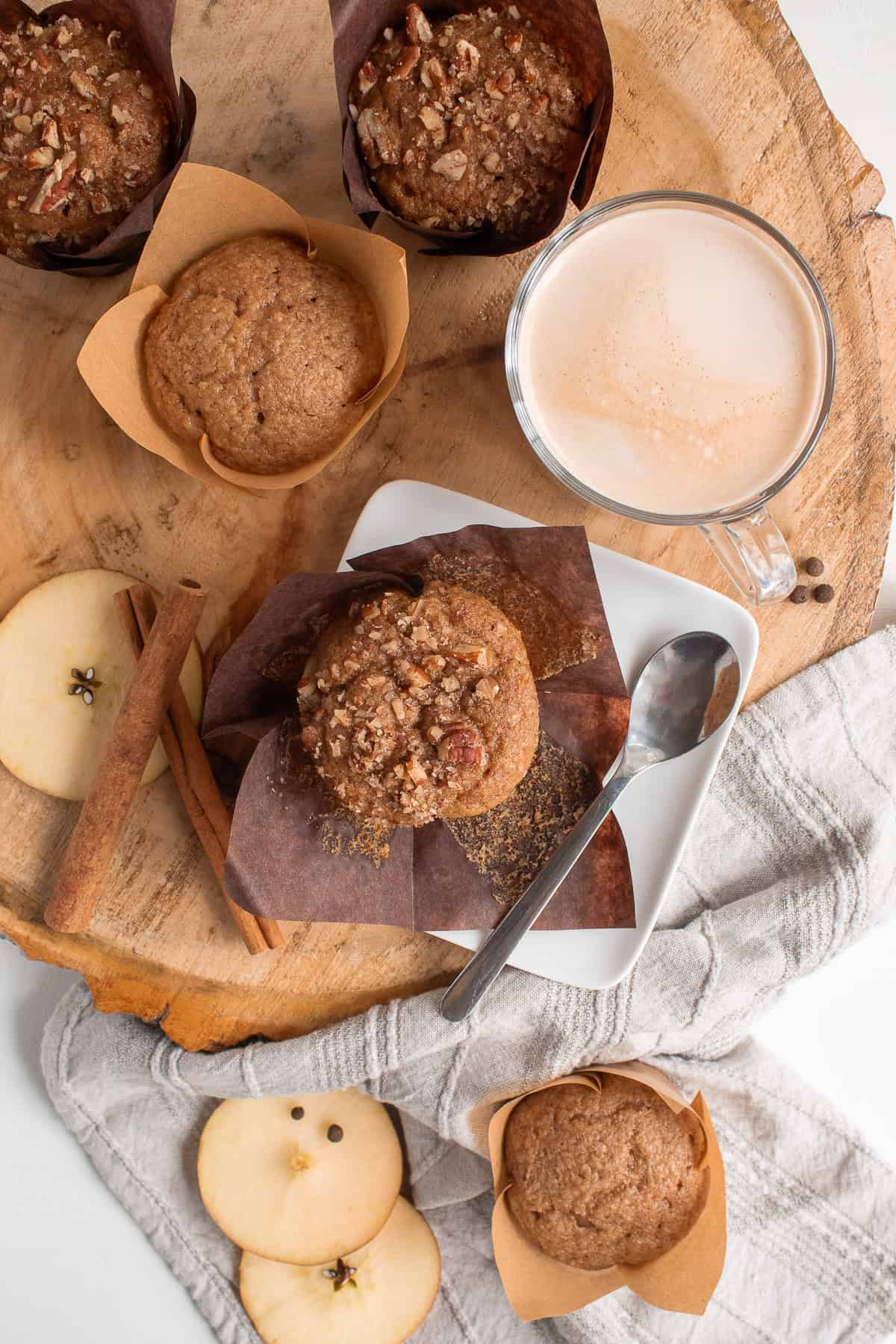 Applesauce muffins with and without pecans are served alongside milky coffee.
