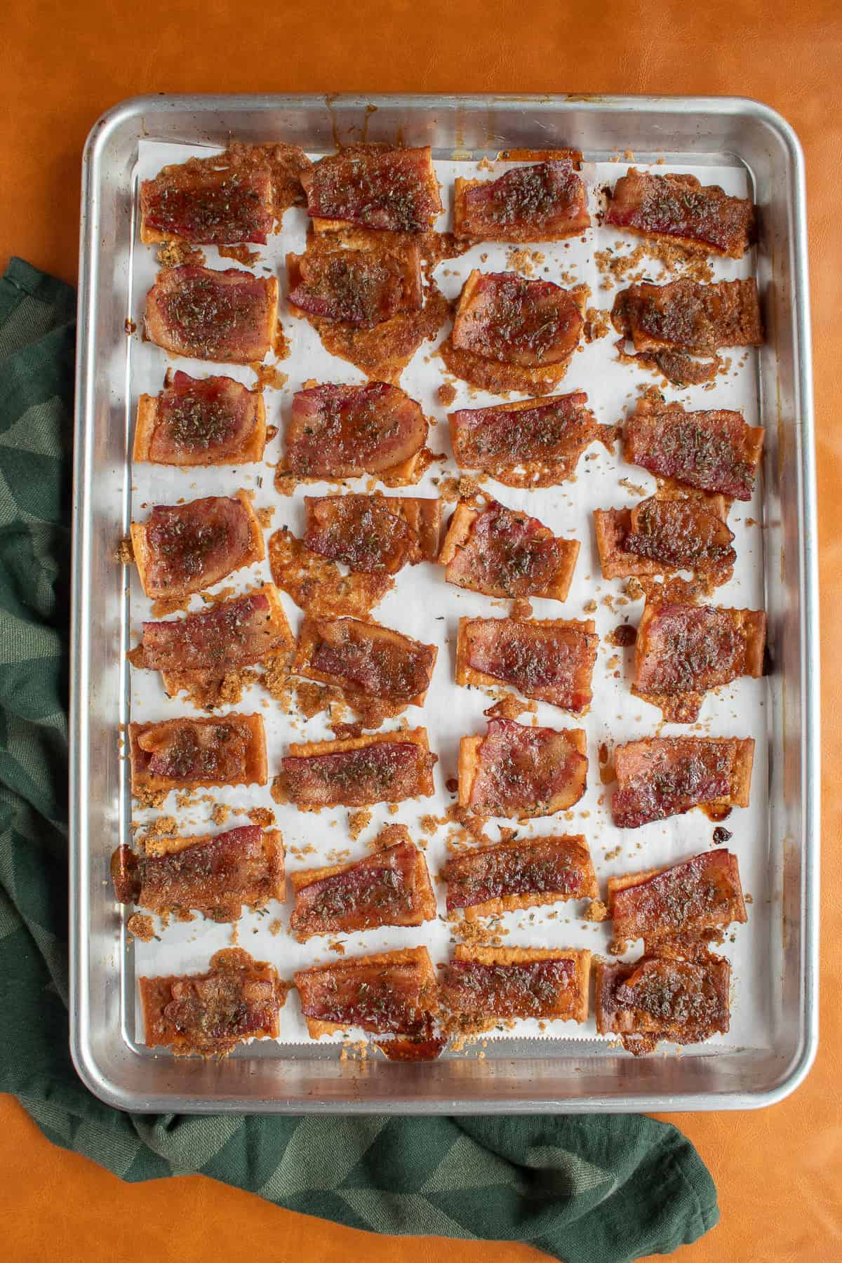 The baked crackers cool on the sheet pan.
