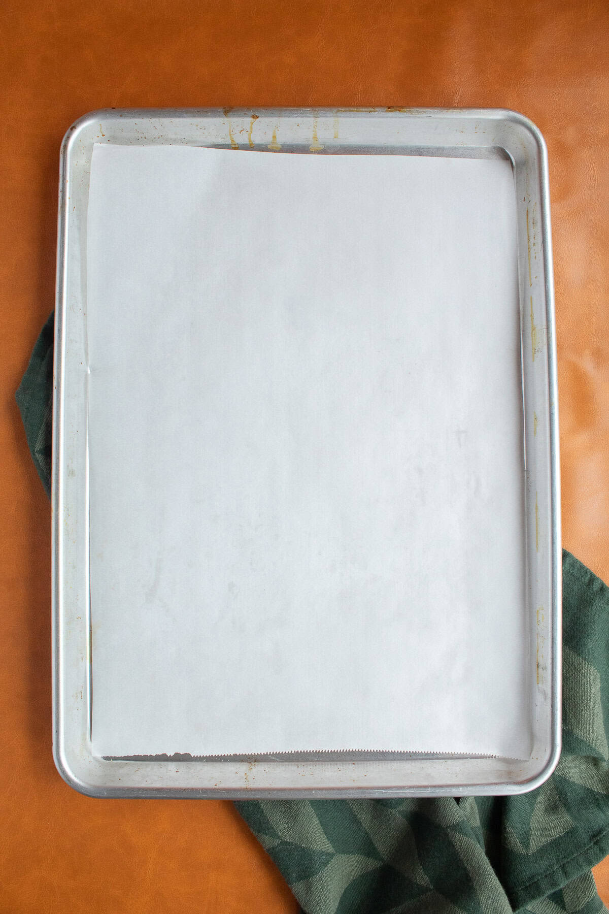 A sheet pan is lined with a sheet of parchment paper.