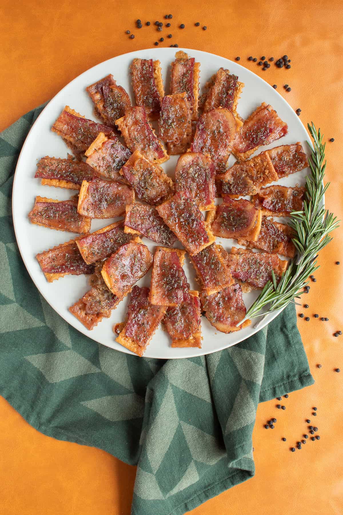 Candied bacon crackers are displayed on a round platter.