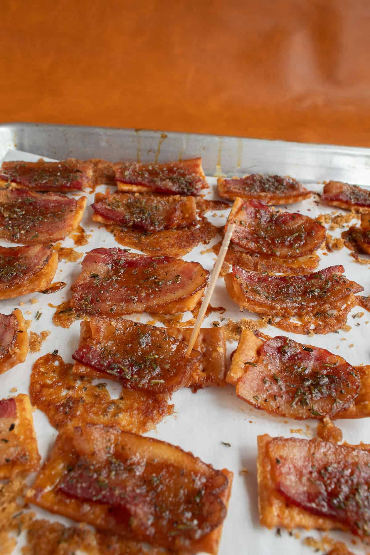 A toothpick can help keep curly bacon slices laying flat.