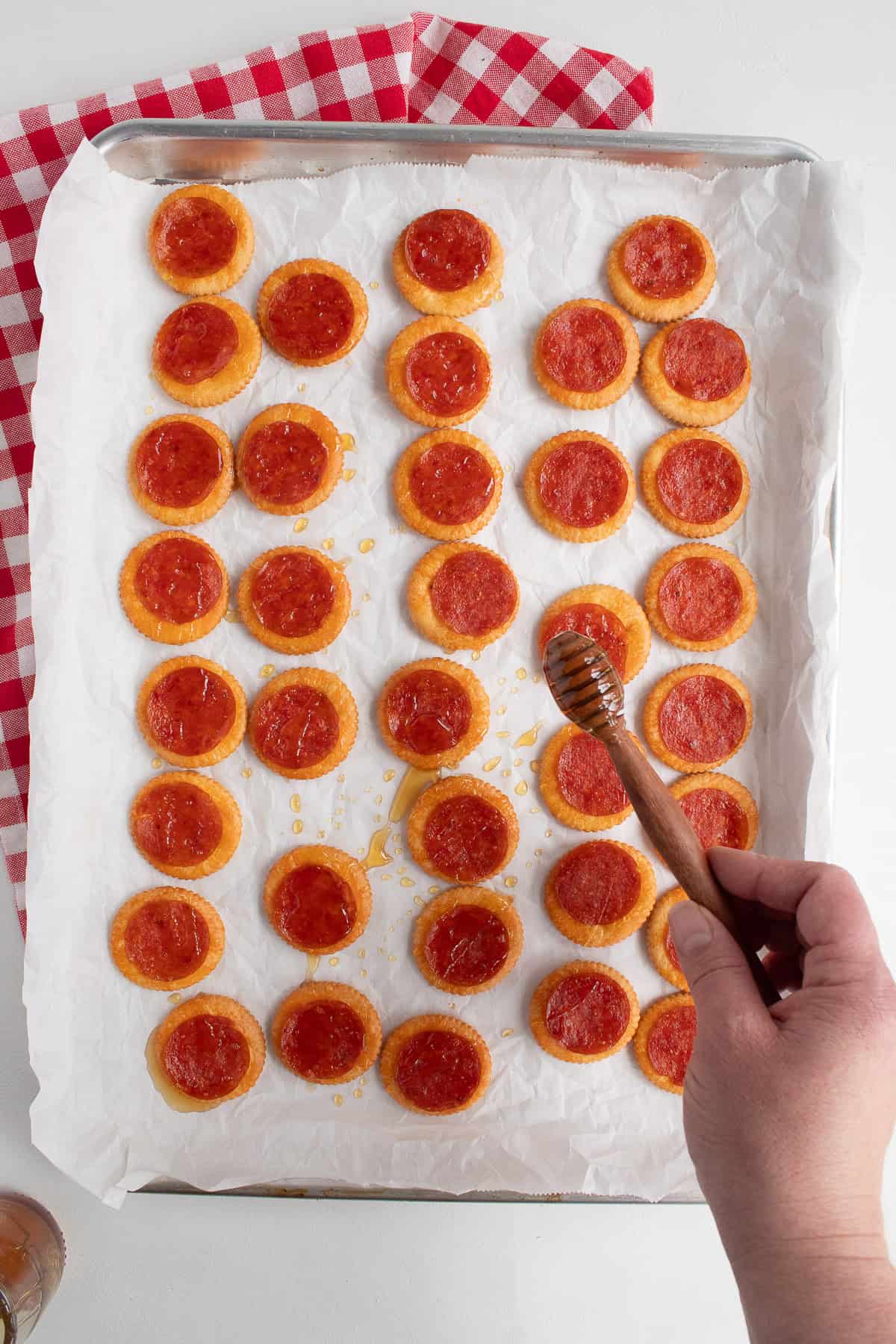 Honey is drizzled over the baked crackers.