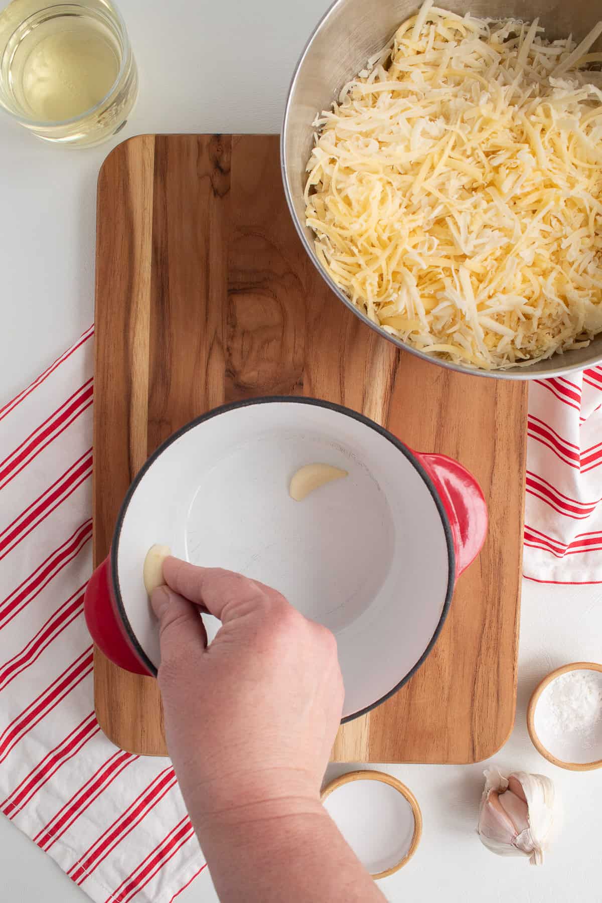 The fondue pot is rubbed with the cut side of a garlic clove.