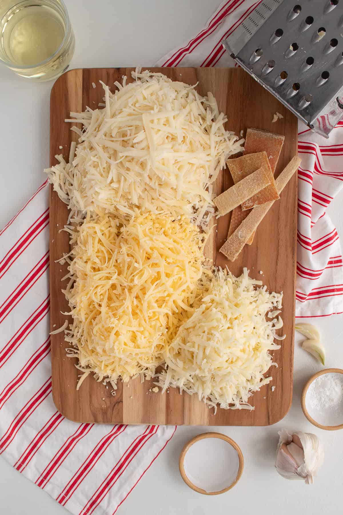 Comté, Gruyère, and Emmental are trimmed and shredded.