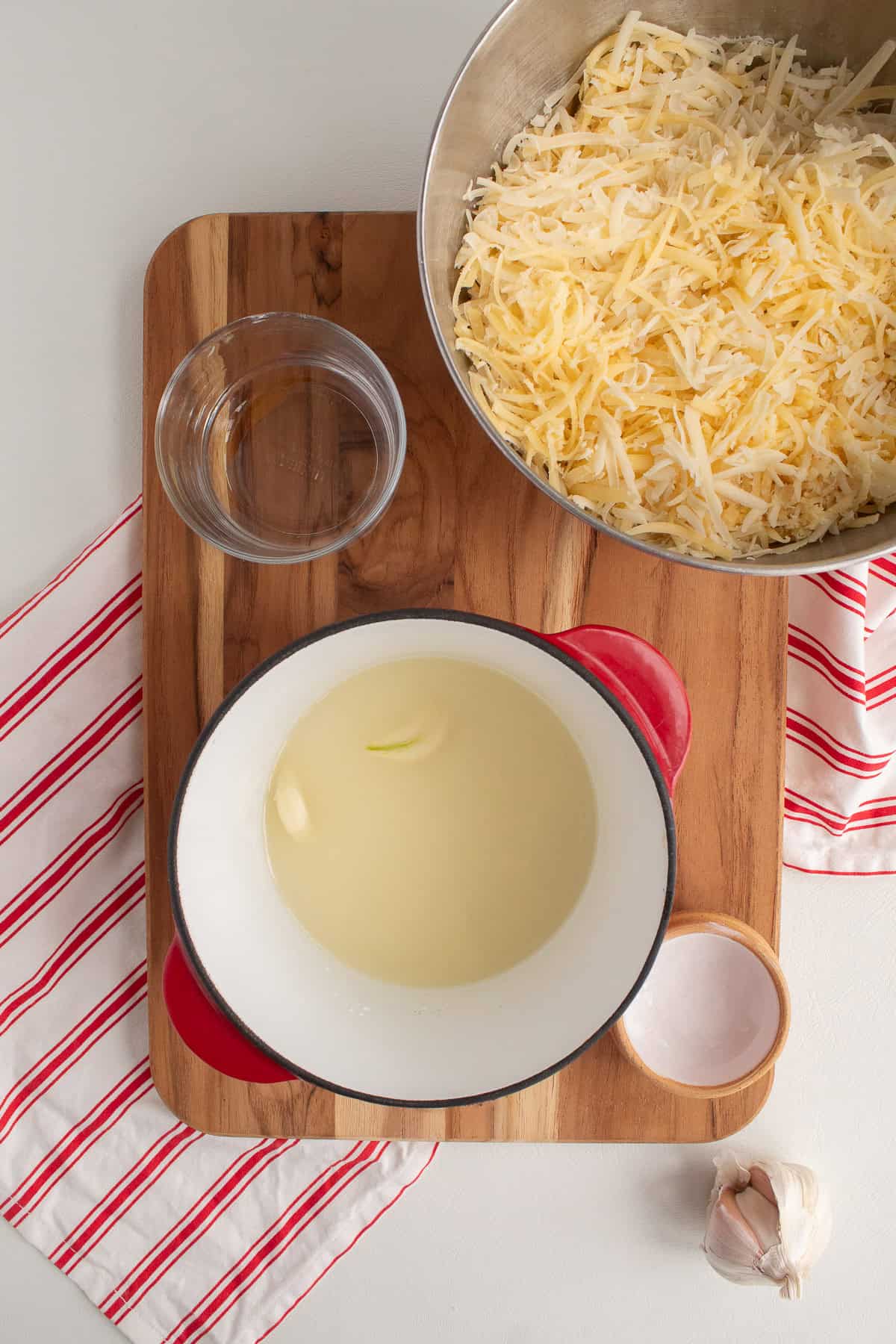 White wine, garlic, kirsch, and cornstarch are added to a sturdy pot.