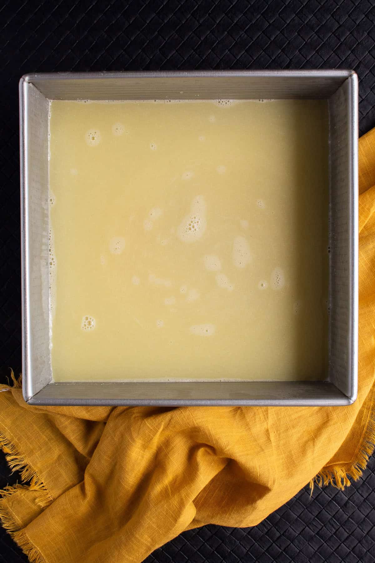 The flavored broth is transferred to the baking dish.