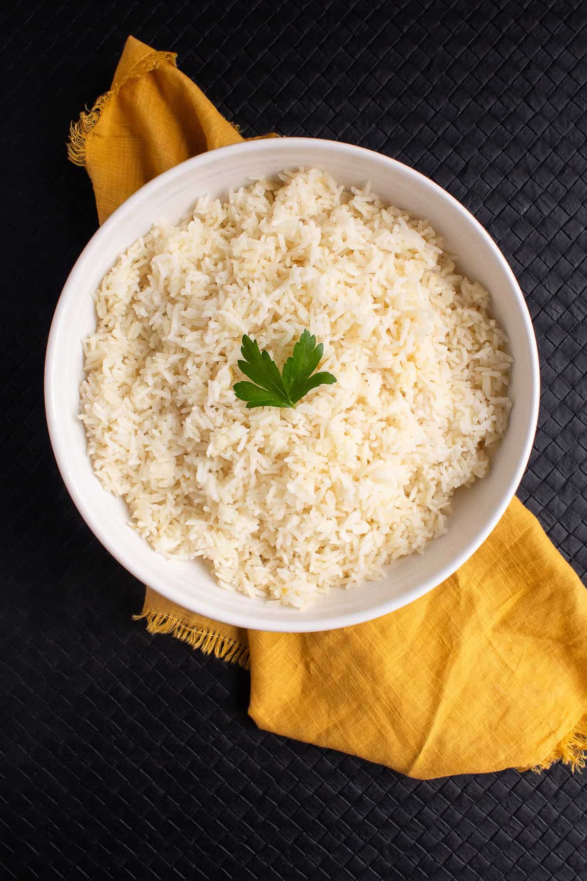 The fluffy rice is garnished with parsley.