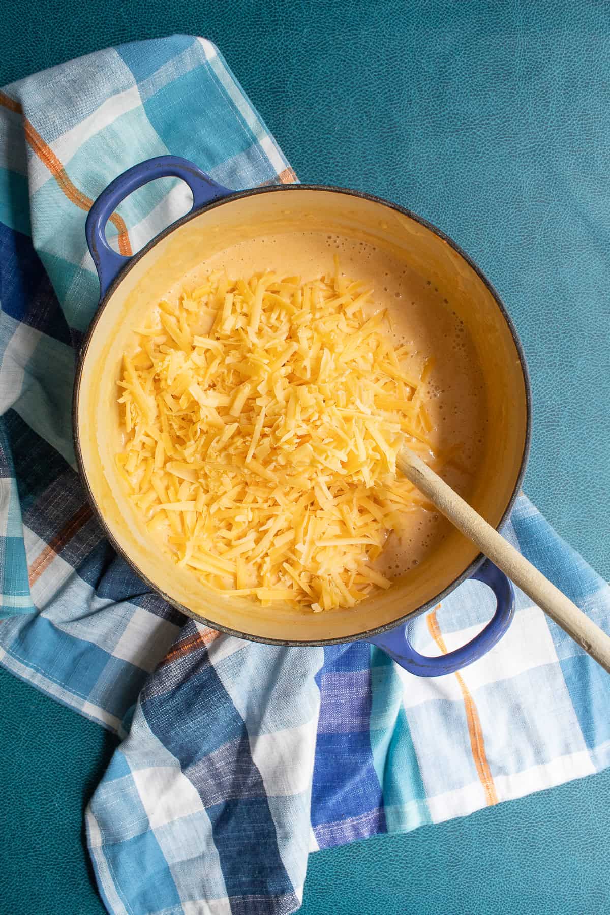 Shredded cheese is added to the soup off of the heat.