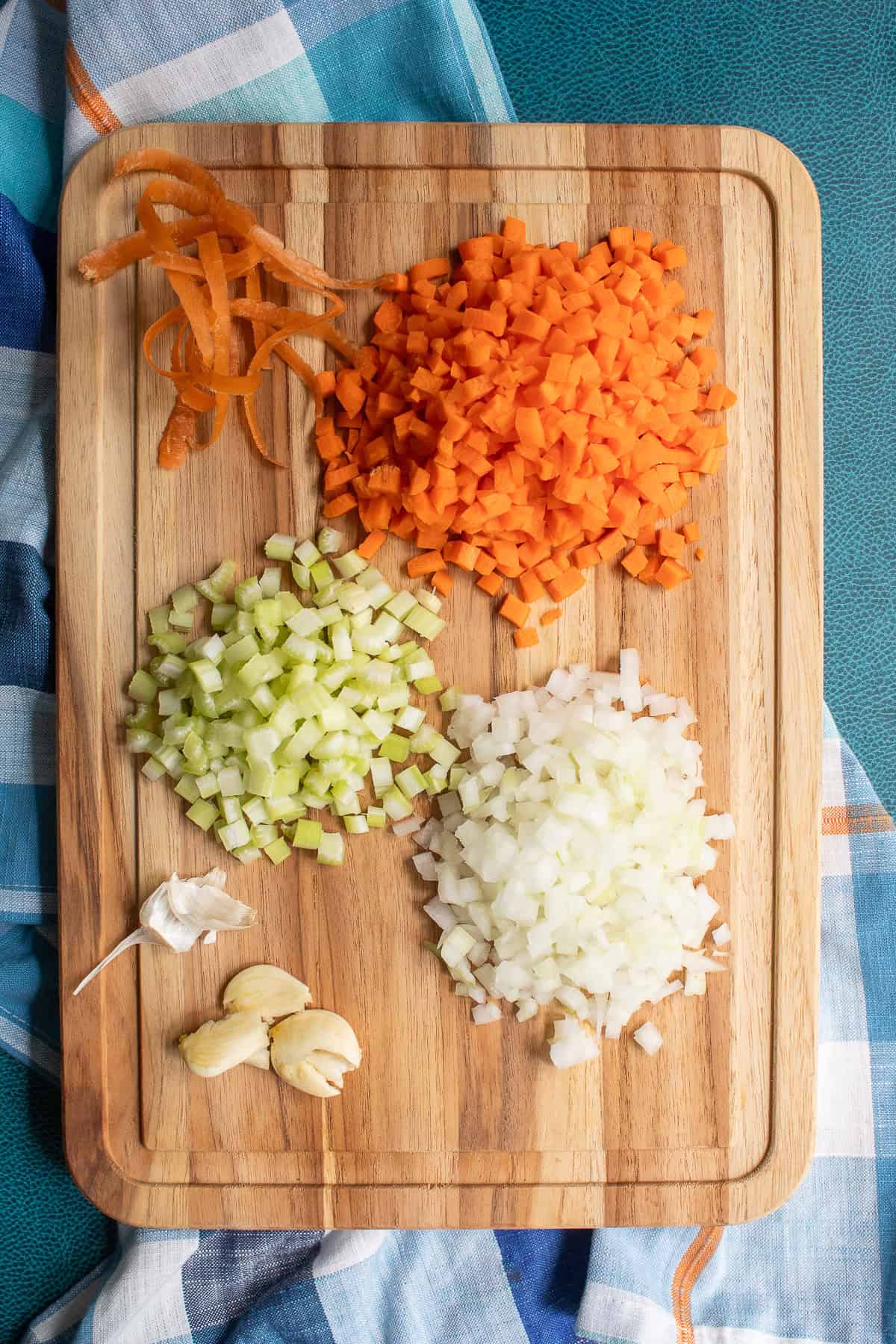 The vegetables are diced into ¼-inch pieces and the garlic is crushed.