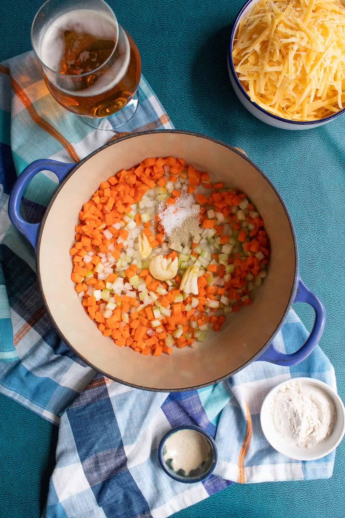 The carrots, onion, and celery (also known as mirepoix) are sauteed along with the garlic, salt, and pepper in a large soup pot.