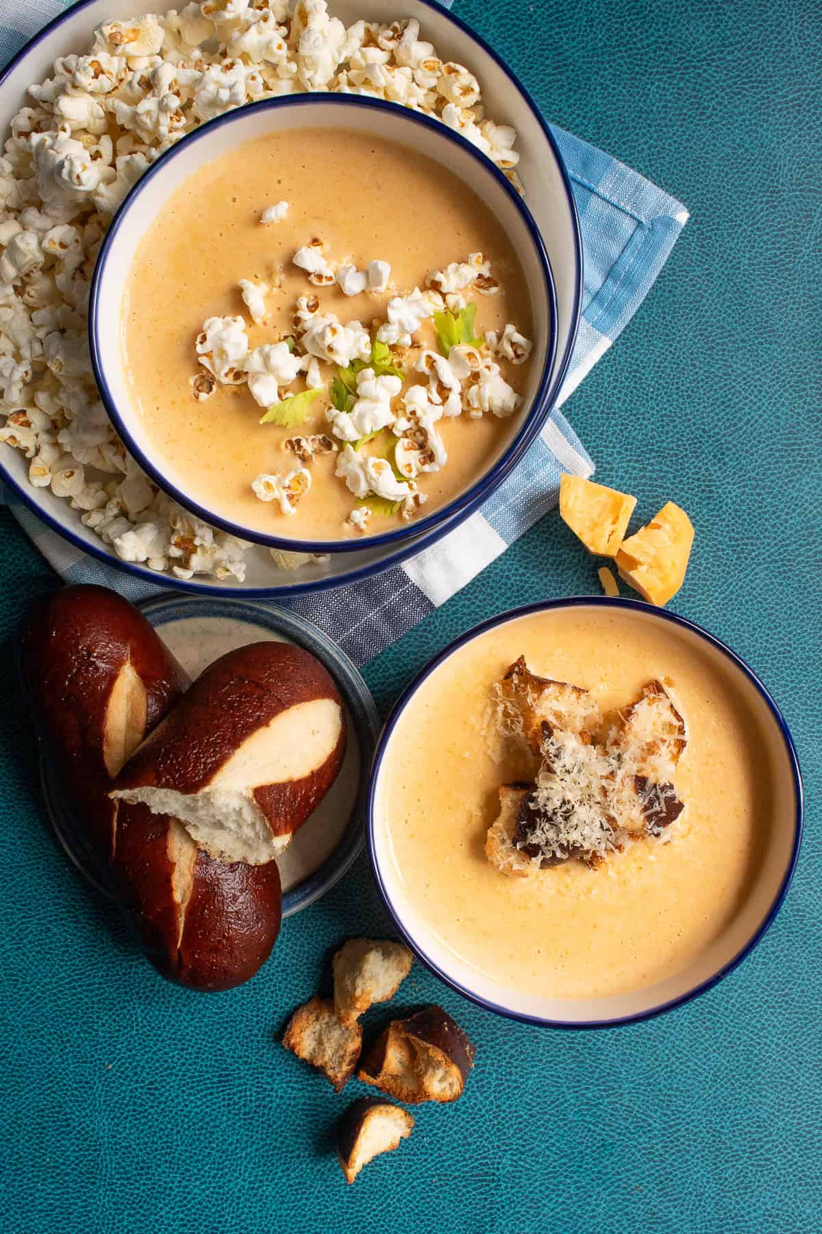 The beer cheese soup is served with two garnishes; popcorn or pretzel bread croutons.