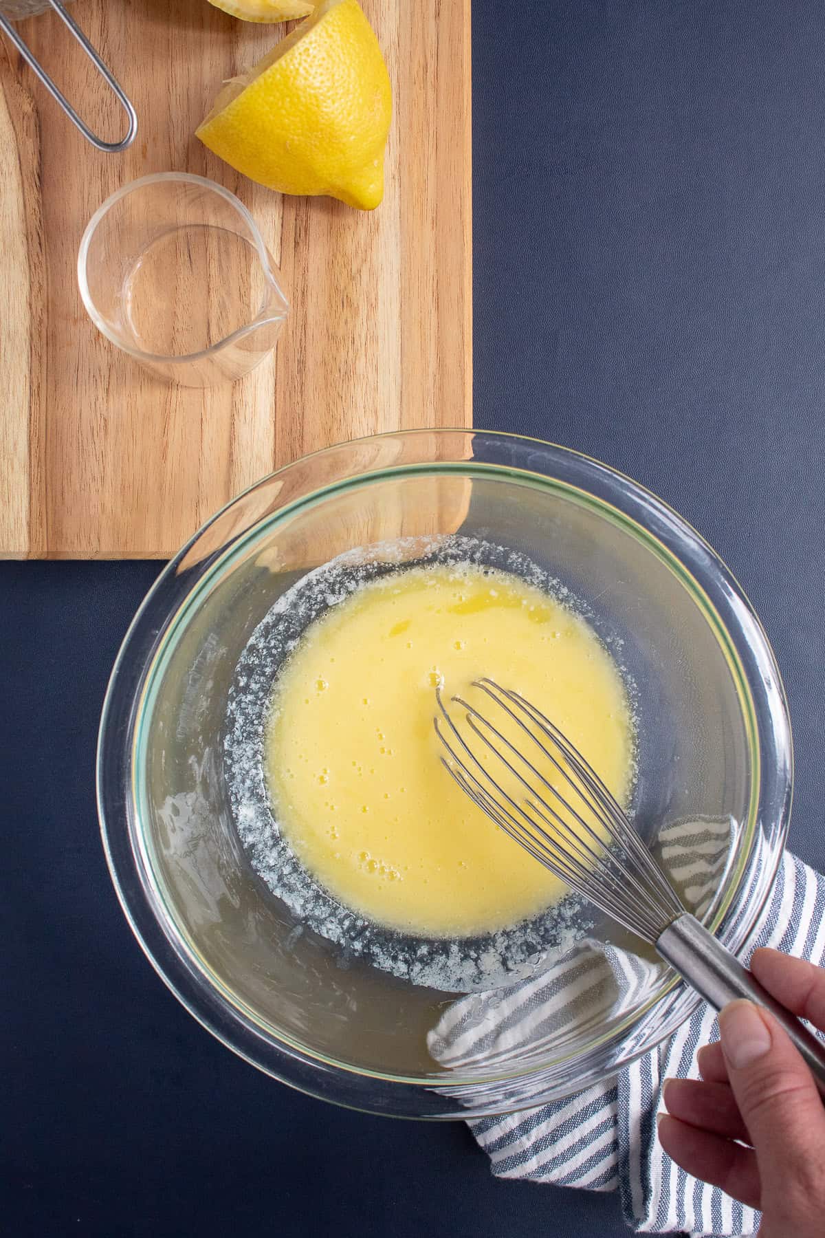 Lemon juice is added to melted butter.