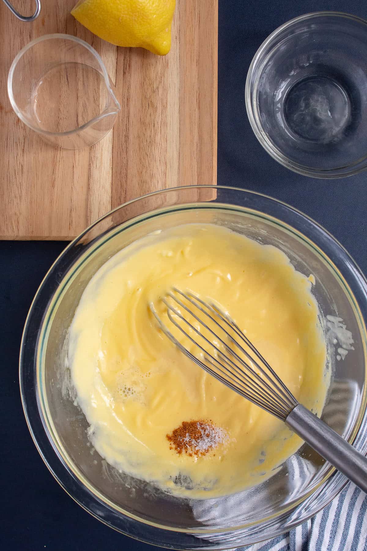 The sauce whisks to a smooth texture before cayenne, water, and salt are added.