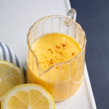 The finished sauce is transferred to a serving pitcher and garnished with cayenne.