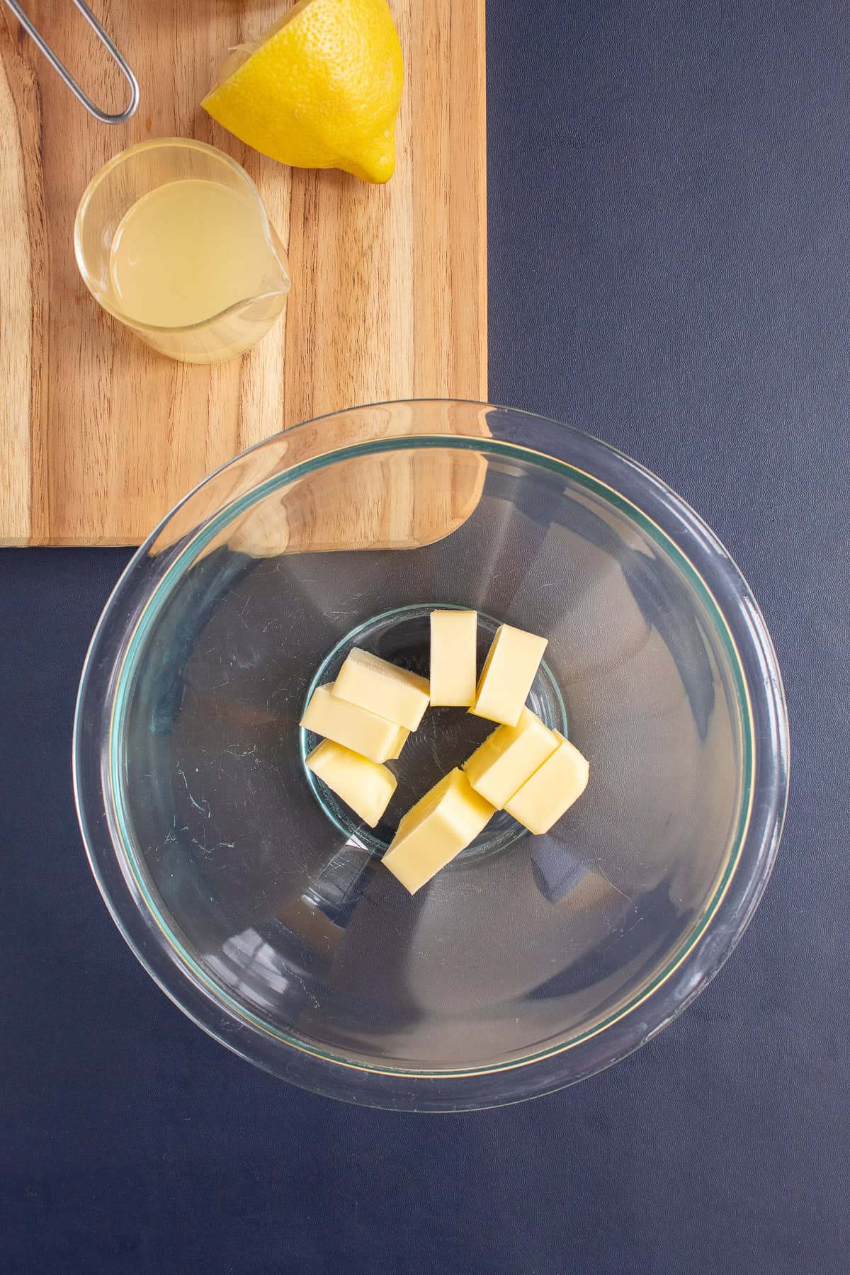Salted butter is added to a microwaveable bowl.