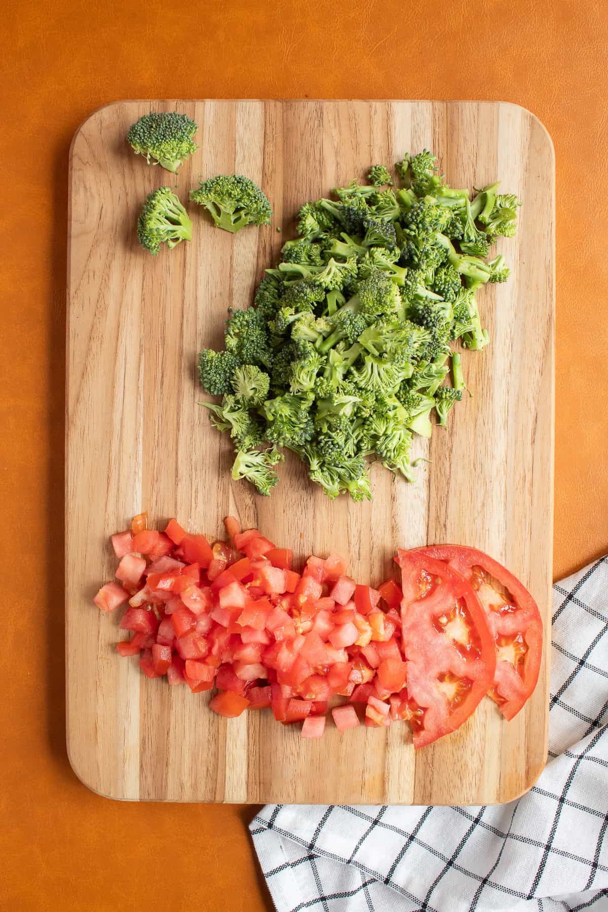Broccoli is finely chopped and tomato is diced.